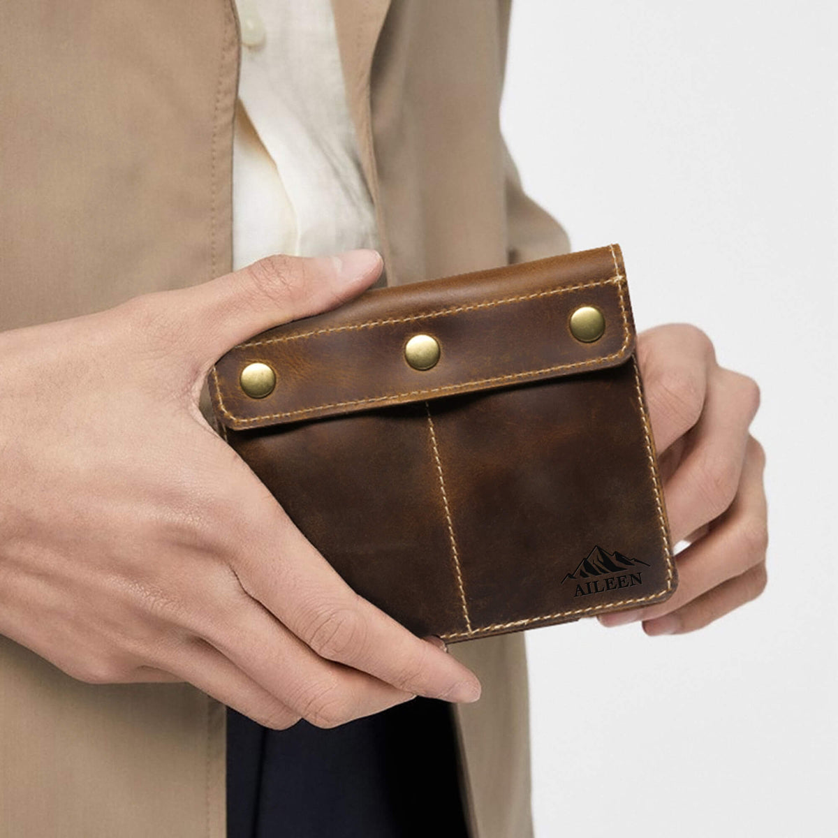 Man holding slim double watch pouch showing compact travel size