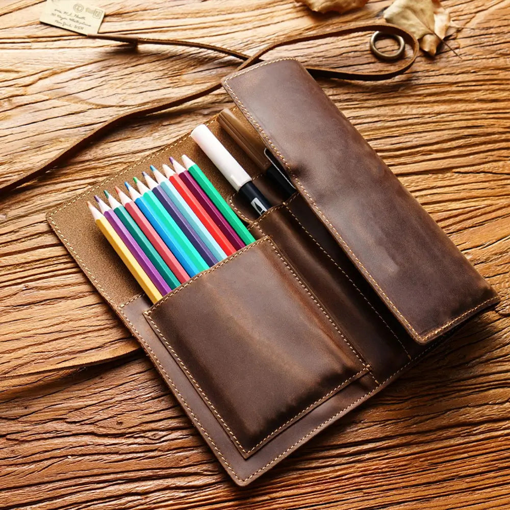 Roll-up leather pen case open showing 7 pen slots and pockets