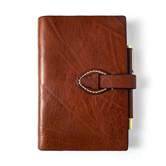 Brown refillable leather journal with strap closure front view