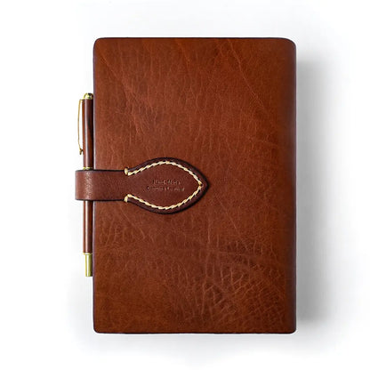 Leather journal strap closure detail with hand stitching