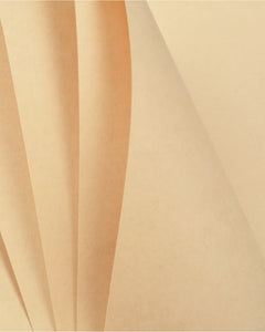 A close-up of folded beige paper or cardstock layers with soft shadows and a warm cream tone.