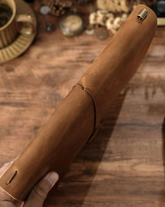 Close-up of Cognac leather journal cover with elastic closure and pen holder
