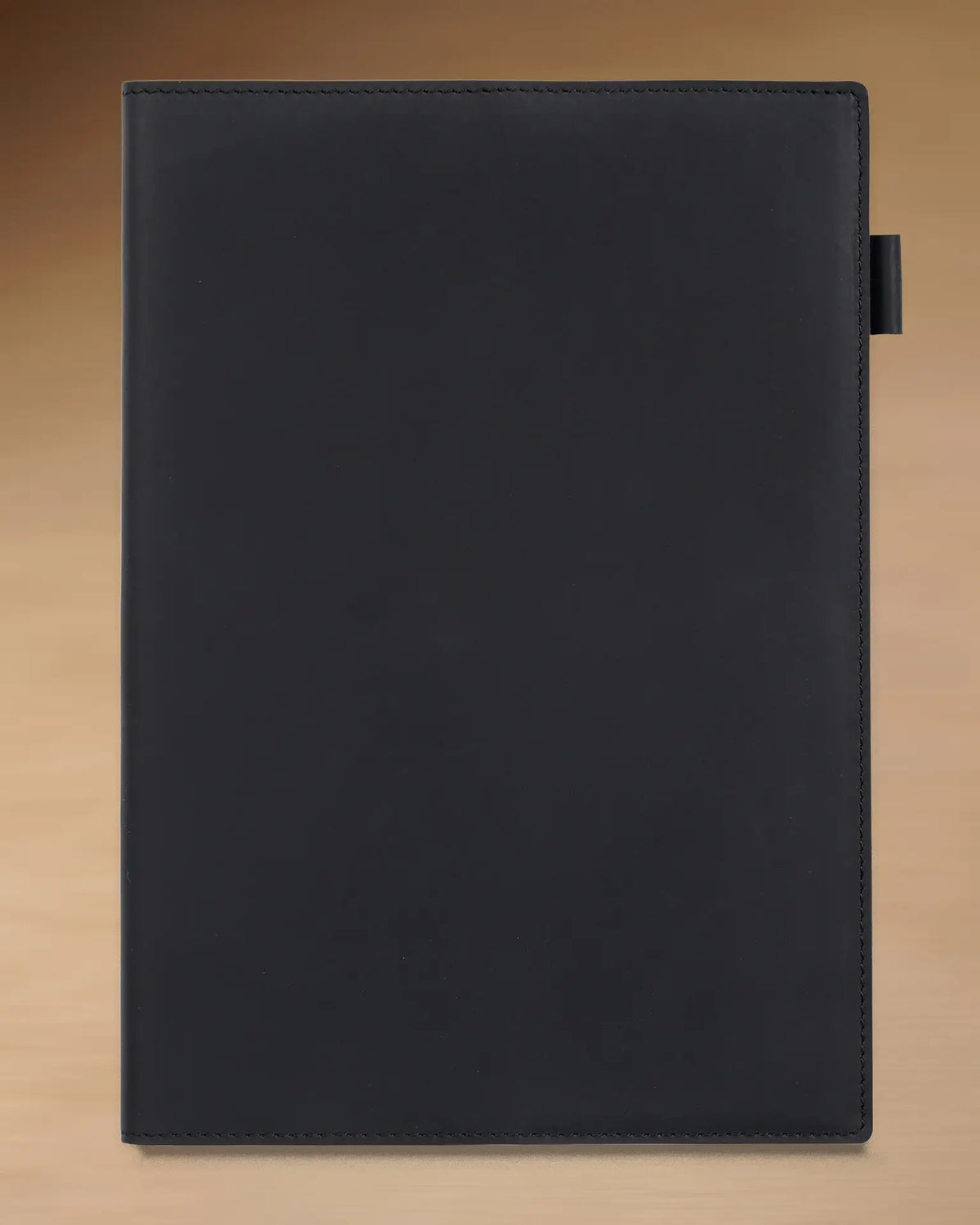 Black B5 refillable leather journal with stitched cover and built-in pen loop

