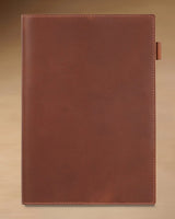 Cognac B5 refillable leather journal with stitched cover and built-in pen loop
