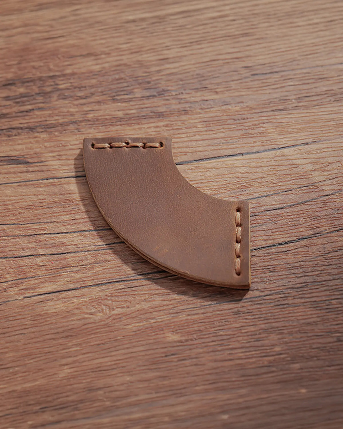 Cognac leather corner bookmark with curved fan design and matching stitching