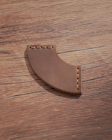 Cognac leather corner bookmark with curved fan design and matching stitching