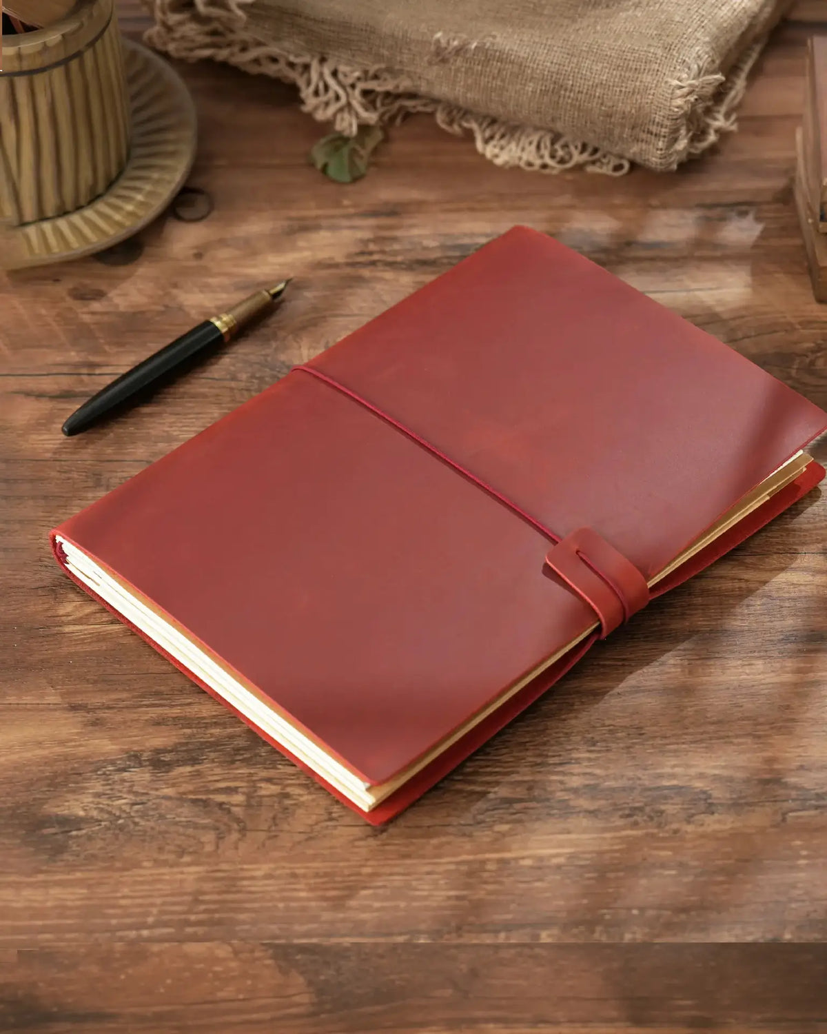 Crimson B5 refillable leather traveler’s notebook with elastic closure
