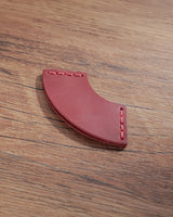 Crimson red leather corner bookmark with fan-shaped profile and stitched ends