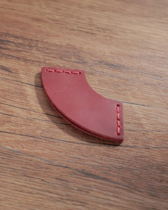 Crimson red leather corner bookmark with fan-shaped profile and stitched ends