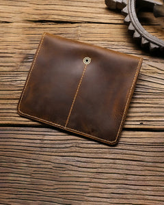 Rear view of a closed brown double-watch sleeve on wood