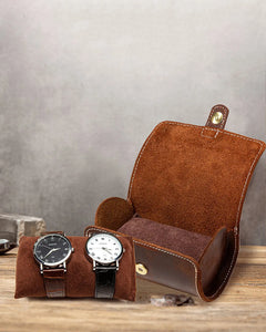 Open double-watch roll beside two watches on a removable pillow