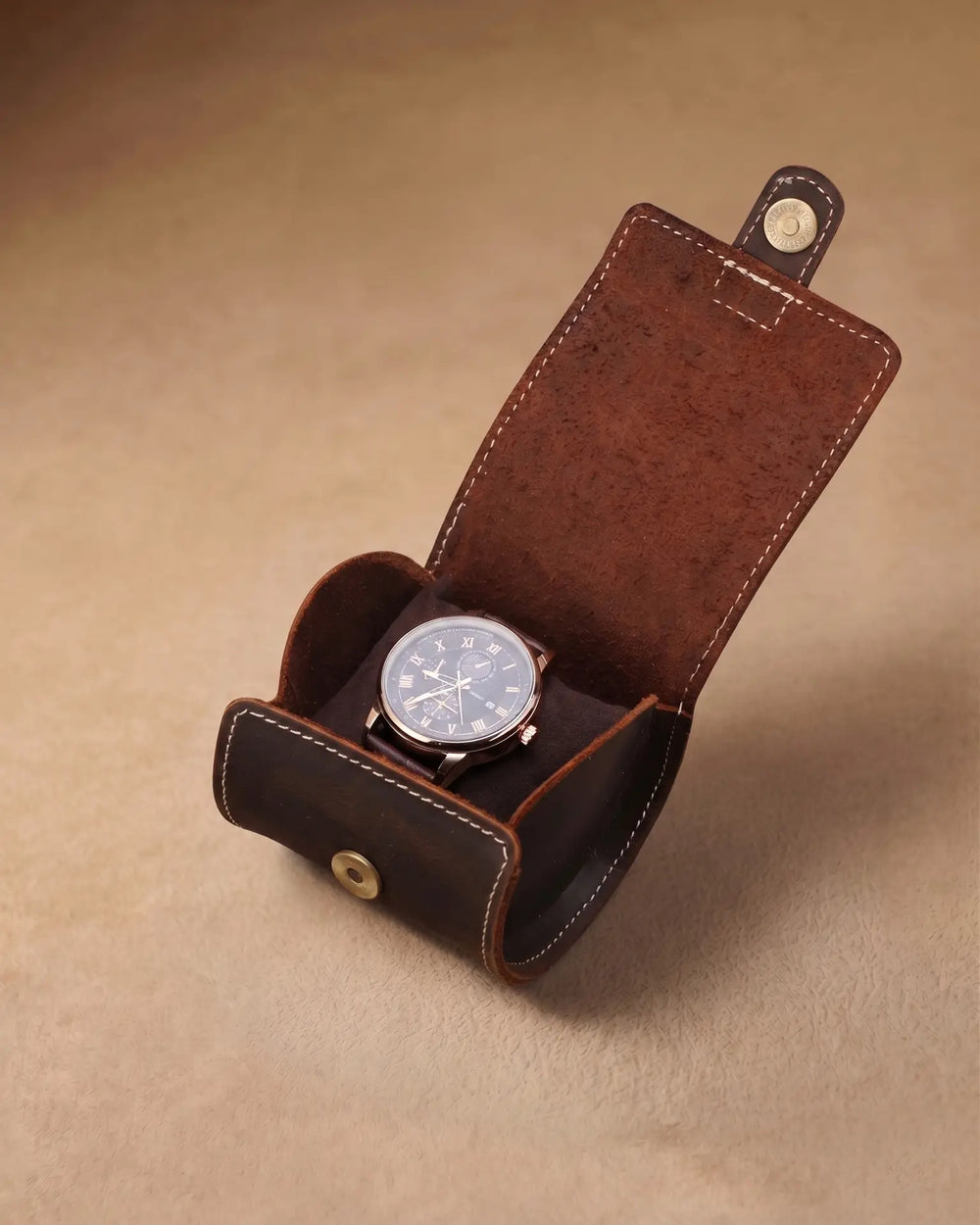 Open warm brown single-watch roll holding a watch