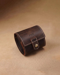 Closed dark brown single-watch roll with engraved initials