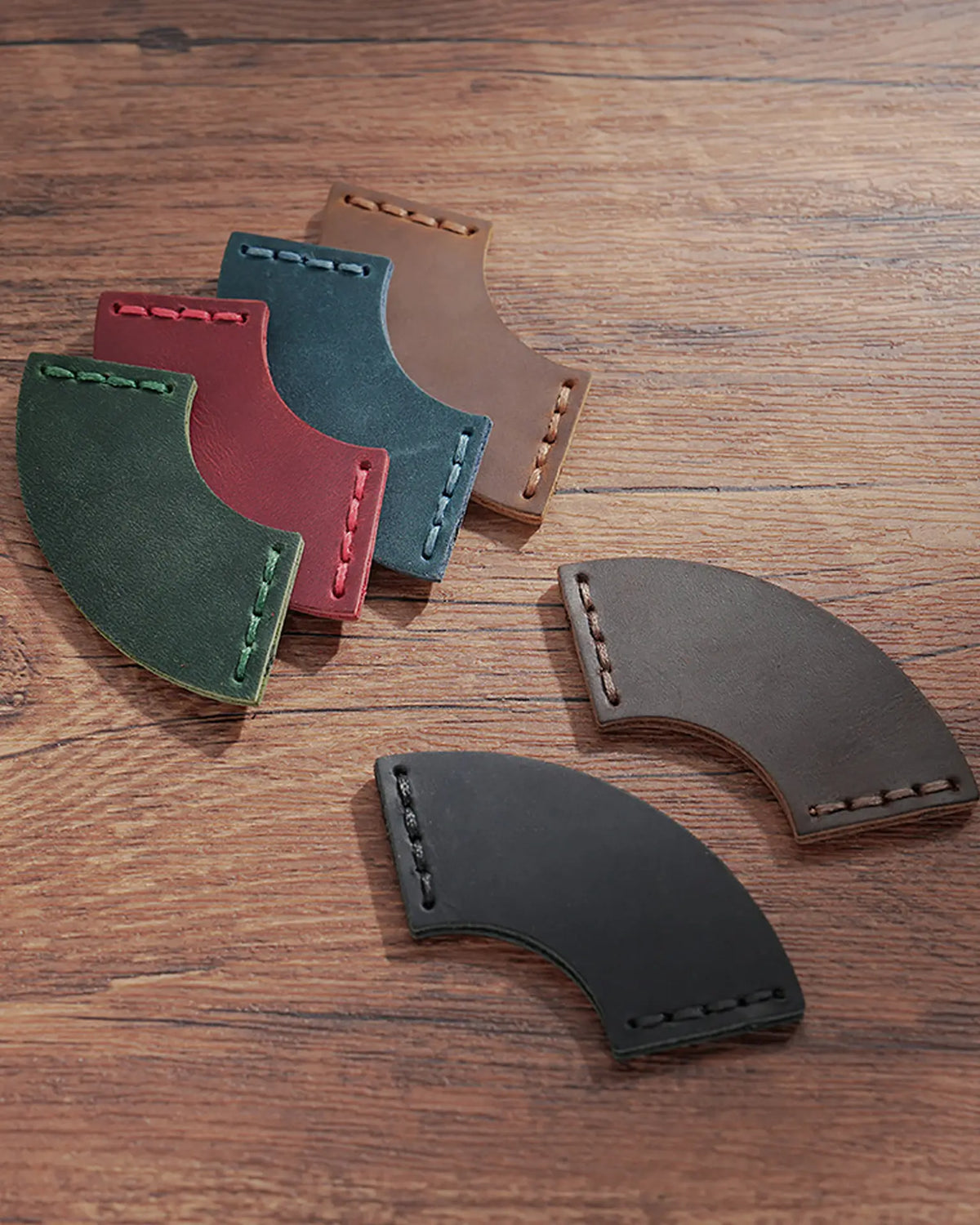 Leather corner bookmarks displayed in Black, Cognac, Crimson, Espresso, Forest Green, and Teal Blue
