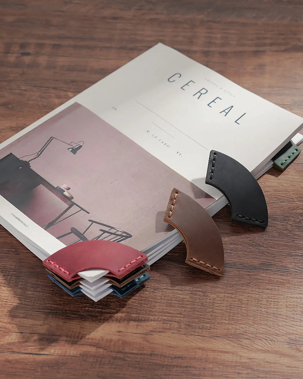 Colorful leather corner bookmarks marking pages in a book
