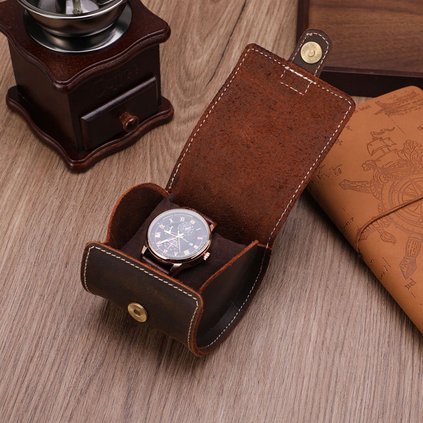 Two leather watch roll cases showing vintage dark brown finish
