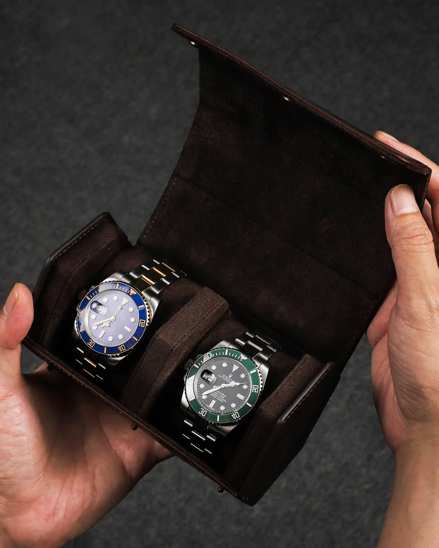 Hands holding open Legacy Hex double watch box with two watches inside