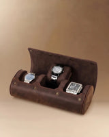 Open dark brown three-watch roll holding three watches