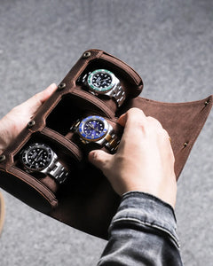 Hands placing a watch into an open three-watch roll