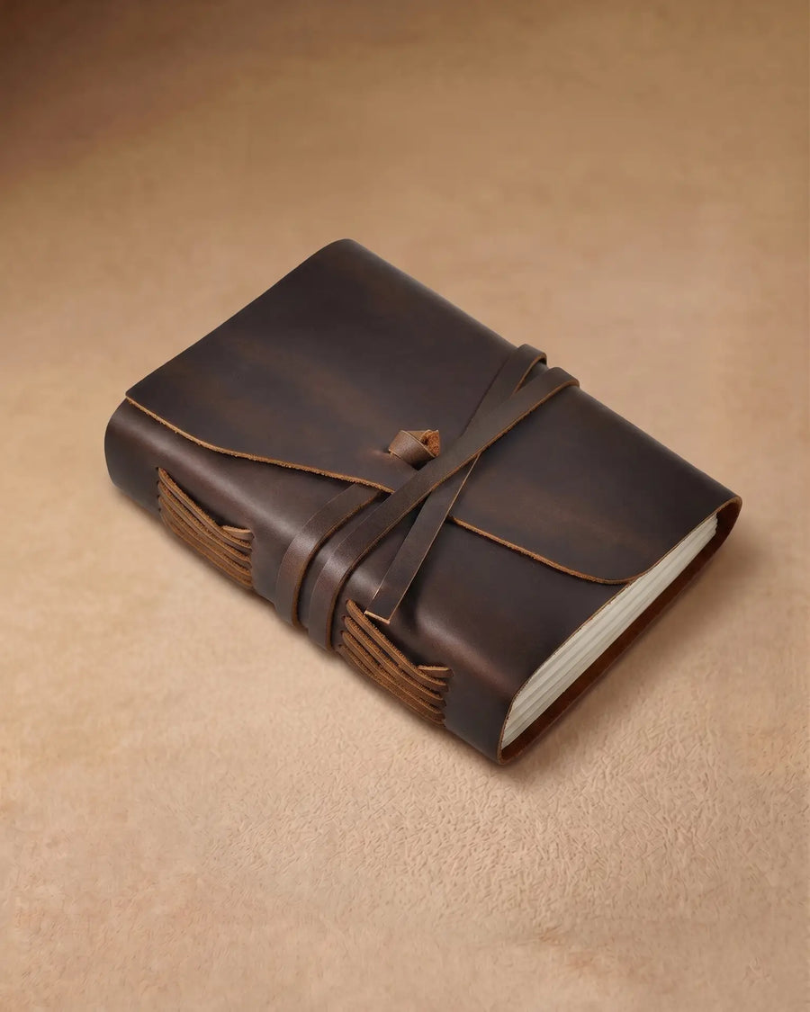 Closed dark brown wrap journal in a front three-quarter view