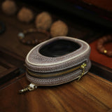 Coffee-colored full grain leather window pouch with ivory piping edge detail