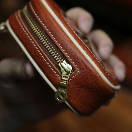 YKK antique brass zipper close-up on handcrafted BygoneMark leather window pouch
