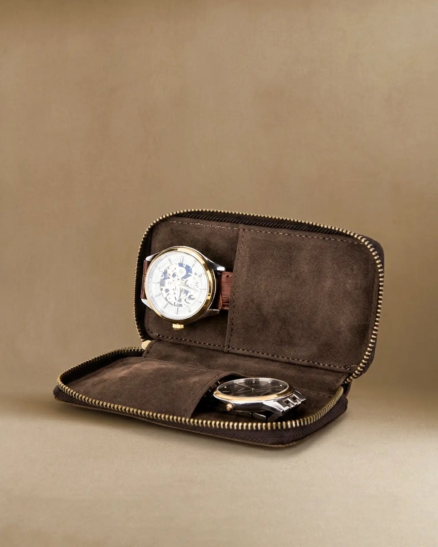 Brown crazy horse leather travel watch pouch with two watches inside showing suede interior