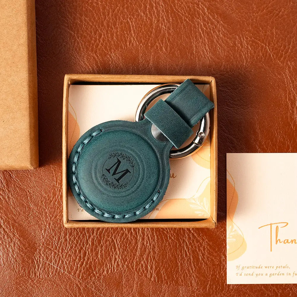 Blue leather AirTag case with custom engraving