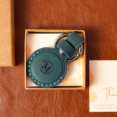 Blue leather AirTag case with custom engraving