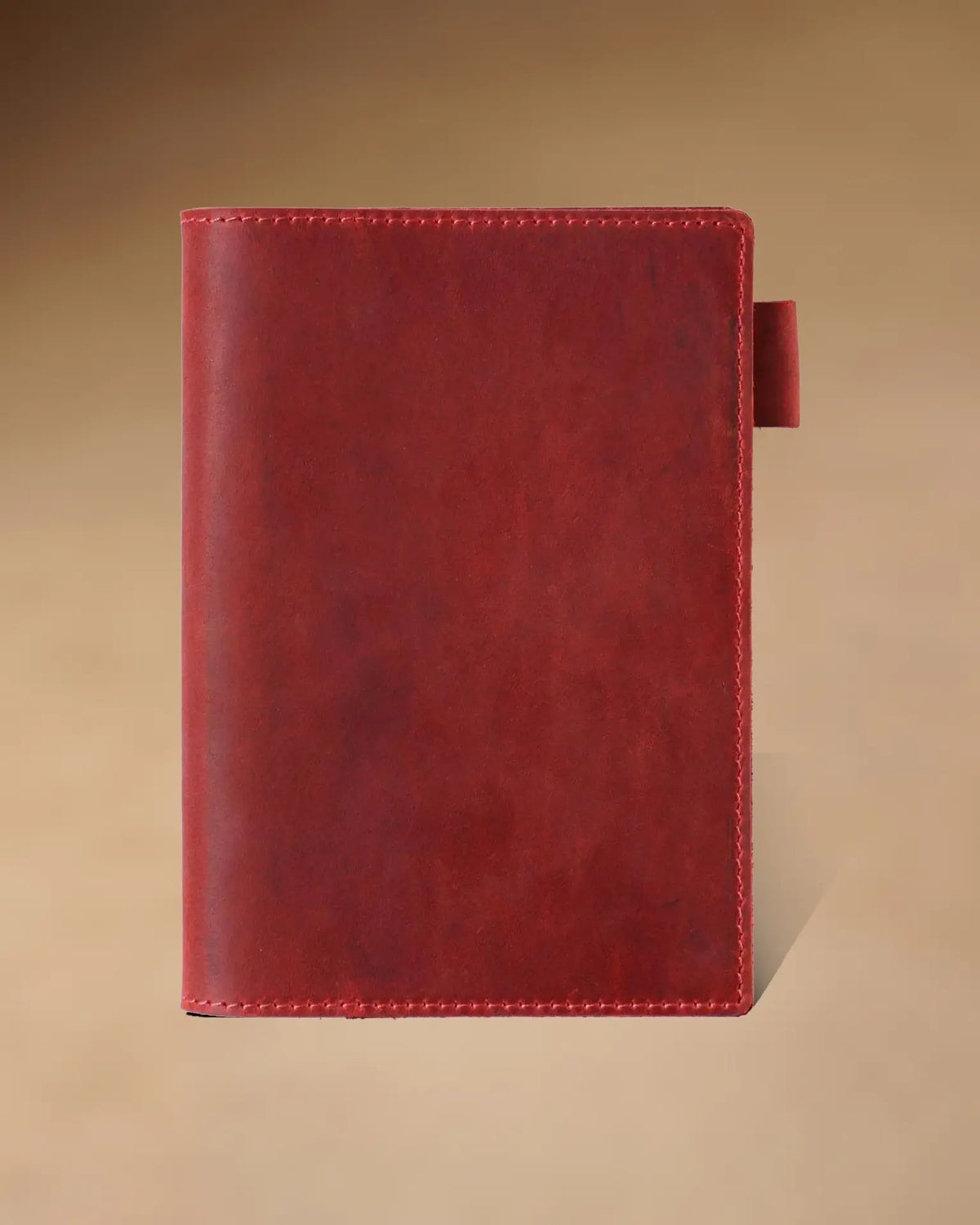 Crimson A6 leather writing folio with stitched cover and pen loop