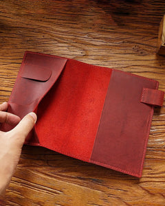 Open Crimson A6 leather writing folio showing interior sleeves and pen loop
