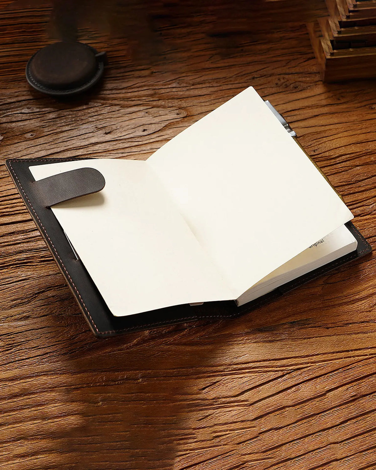 Open A6 notebook inside a leather writing folio
