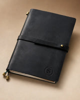 Black A5 leather traveler’s notebook with wrap strap and monogram example
