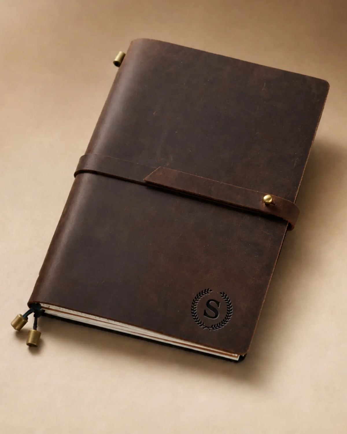 Espresso A5 leather traveler’s notebook with wrap strap and monogram example