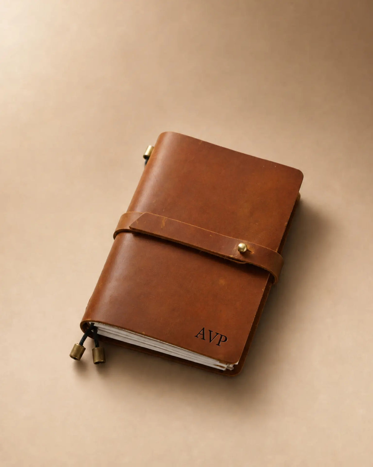 Cognac Passport-Size leather traveler’s notebook with wrap strap and monogram example
