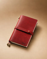 Crimson Personal-Size leather traveler’s notebook with wrap strap and monogram example