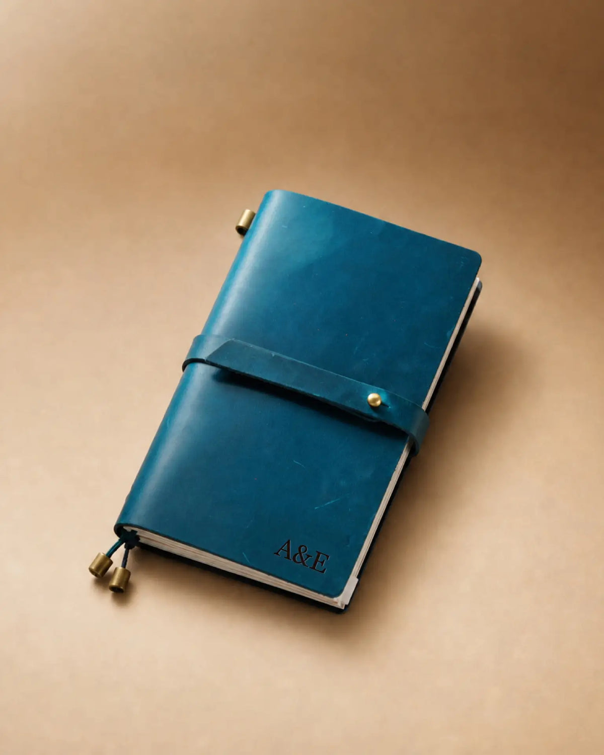 Teal Blue Personal-Size leather traveler’s notebook with wrap strap and monogram example
