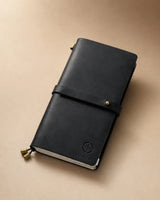 Black Regular-Size leather traveler’s notebook with wrap strap and compass personalization example
