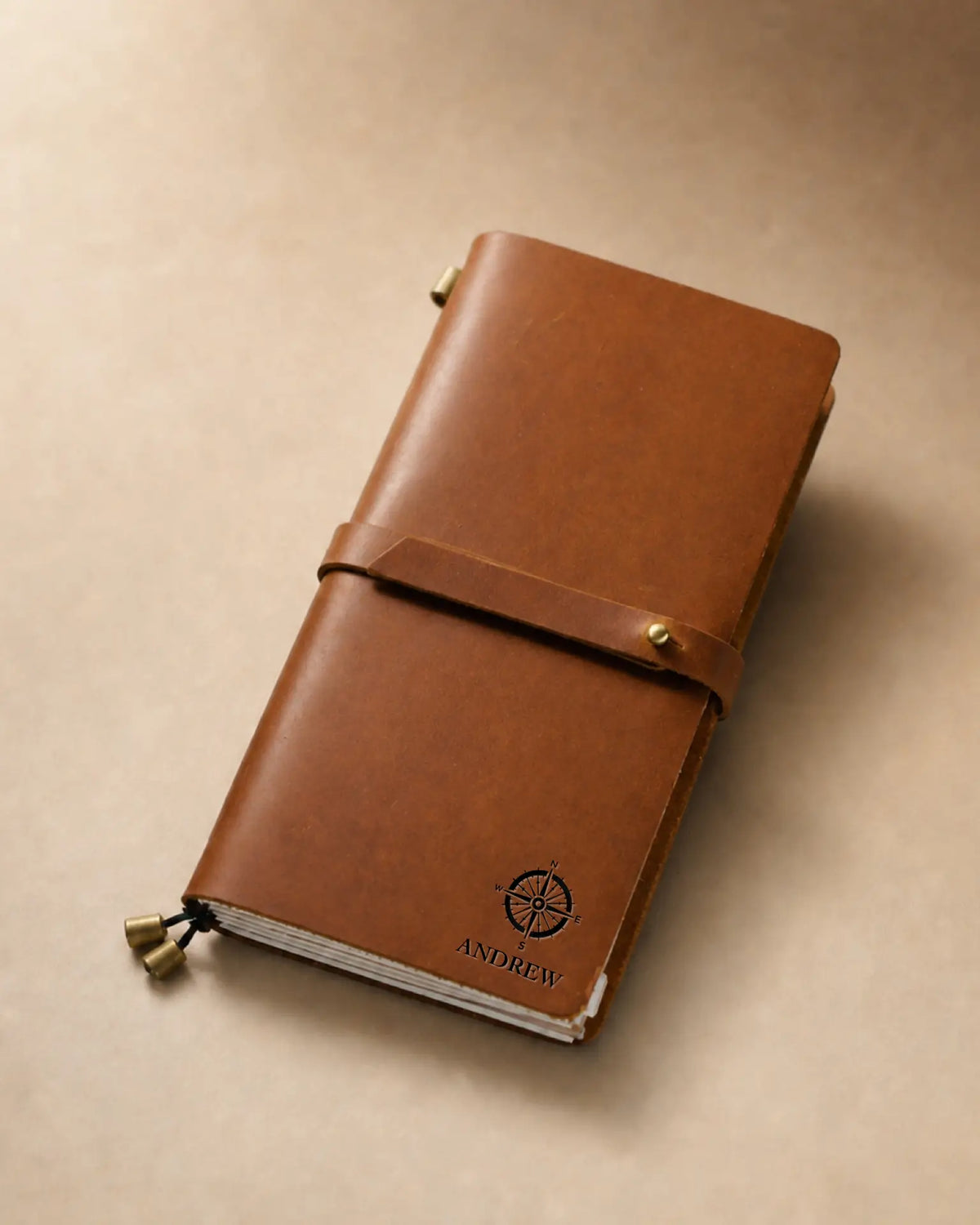 Cognac Regular-Size leather traveler’s notebook with wrap strap and compass personalization example