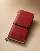 Crimson Regular-Size leather traveler’s notebook with wrap strap and compass personalization example