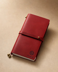 Crimson Regular-Size leather traveler’s notebook with wrap strap and compass personalization example