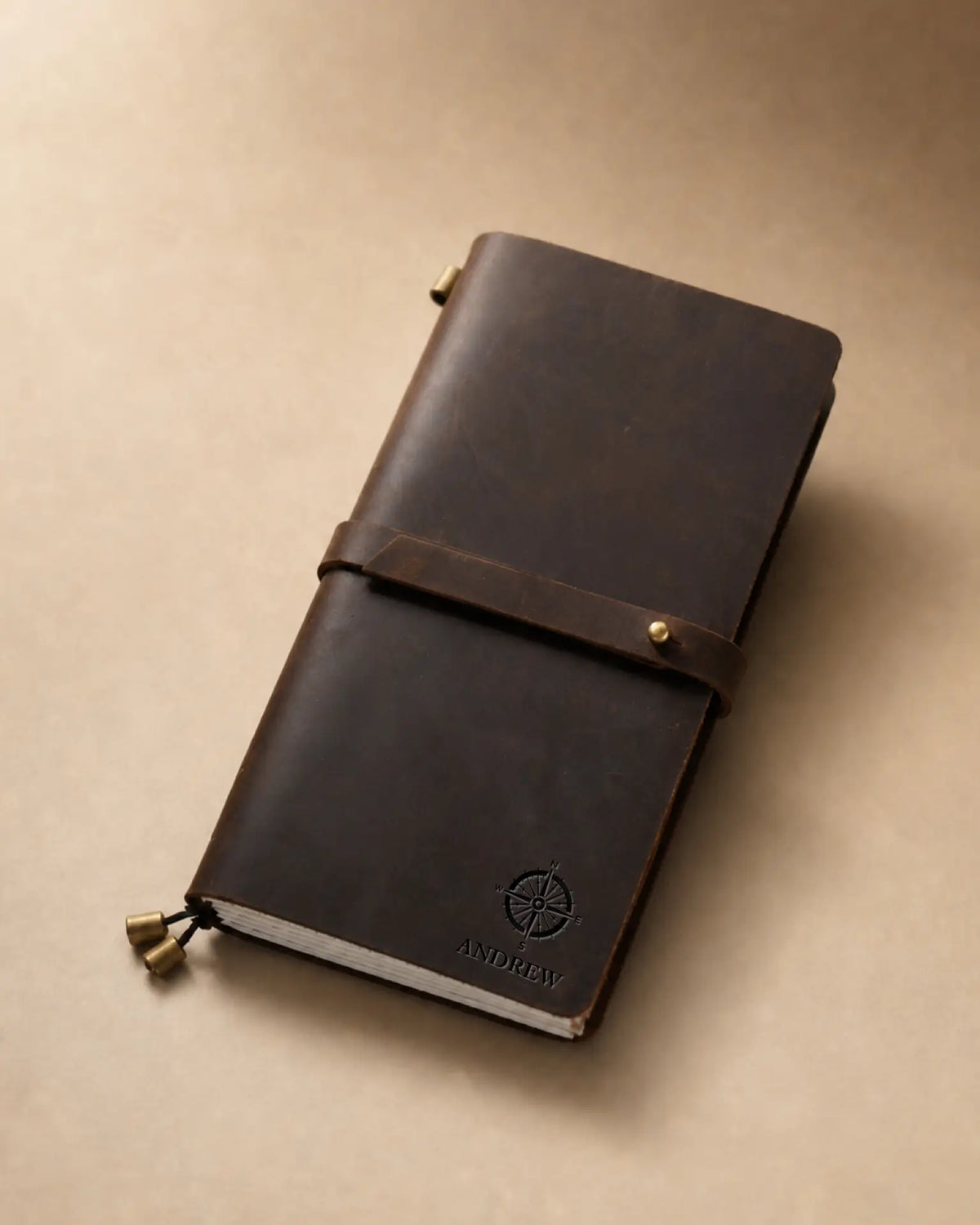 Espresso Regular-Size leather traveler’s notebook with wrap strap and compass personalization example