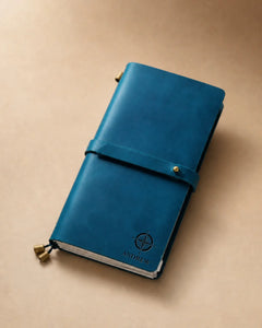 Teal Blue Regular-Size leather traveler’s notebook with wrap strap and compass personalization example