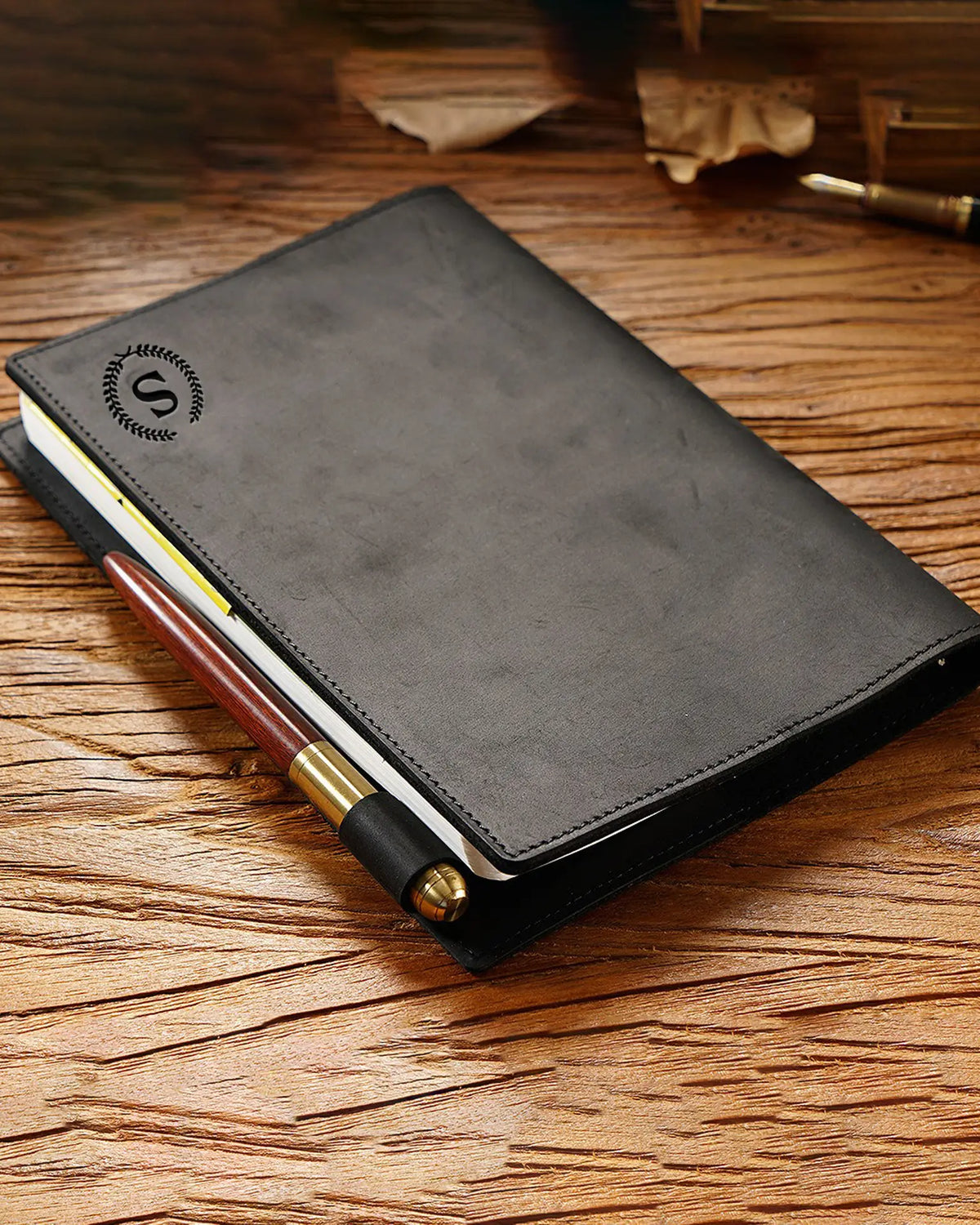 Black A5 leather writing folio shown with an engraved initial