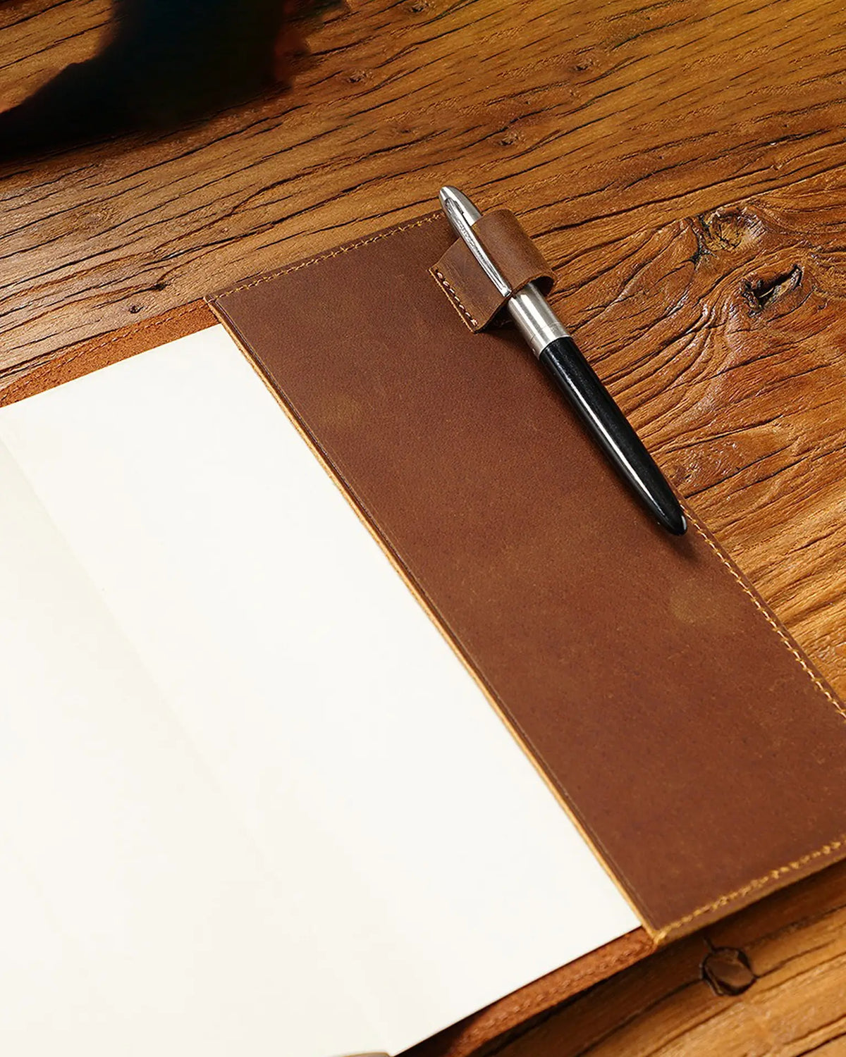 Open Cognac A5 leather writing folio with blank notebook and pen loop
