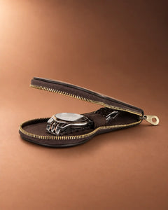 Side view of the open Espresso watch case with a metal-bracelet watch beneath the inner strap.