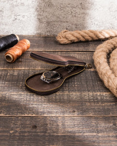 Partially open Espresso watch case with a metal-bracelet watch on a wooden table.