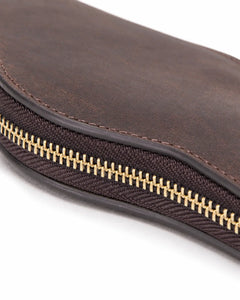 Detail of the gold-tone zipper teeth and stitched edge on the Espresso watch case.