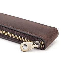 Close-up of the zipper pull and narrow end of the Espresso leather watch case.
