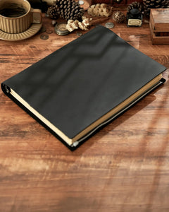 Black Legacy Binder A4 journal on a wooden desk with photography props